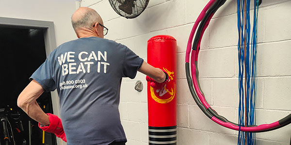 Man with Parkinson’s using boxing punchbag
